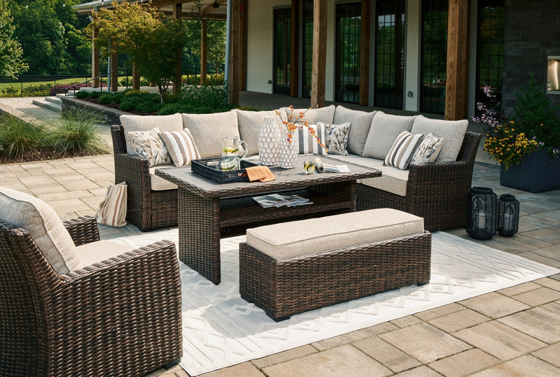 Brook Ranch Outdoor Sectional Set with Lounge Chair and Coffee Table in Brown from Ashley - DMV Furniture