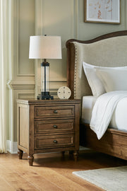 Sturlayne California King Upholstered Panel Bed with Dresser and 2 Nightstands in Brown from Ashley - DMV Furniture