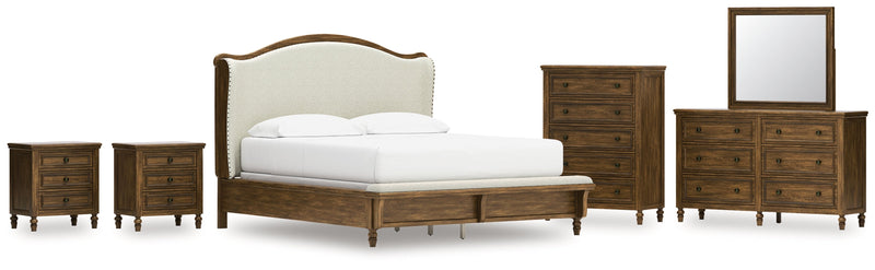 Sturlayne California King Upholstered Panel Bed with Mirrored Dresser, Chest and 2 Nightstands in Brown from Ashley - DMV Furniture