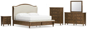 Sturlayne California King Upholstered Panel Bed with Mirrored Dresser, Chest and Nightstand in Brown from Ashley - DMV Furniture