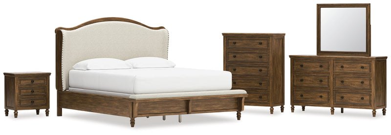 Sturlayne California King Upholstered Panel Bed with Mirrored Dresser, Chest and Nightstand in Brown from Ashley - DMV Furniture
