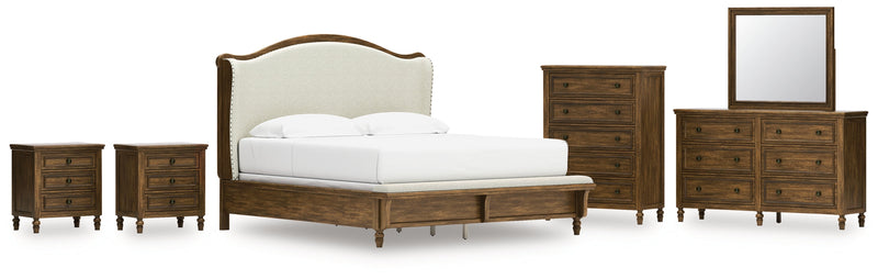 Sturlayne King Upholstered Panel Bed with Mirrored Dresser, Chest and 2 Nightstands in Brown from Ashley - DMV Furniture