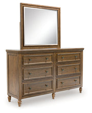 Sturlayne King Upholstered Panel Bed with Mirrored Dresser, Chest and Nightstand in Brown from Ashley - DMV Furniture