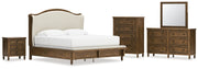 Sturlayne King Upholstered Panel Bed with Mirrored Dresser, Chest and Nightstand in Brown from Ashley - DMV Furniture