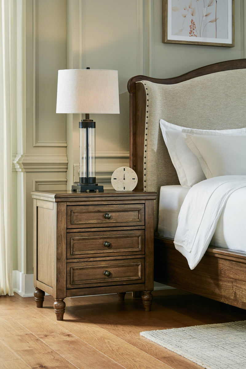Sturlayne King Upholstered Panel Bed with Mirrored Dresser, Chest and Nightstand in Brown from Ashley - DMV Furniture