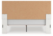 Zuraleus King Upholstered Panel Platform Bed, Dresser, Mirror and Nightstand in White - PKG022818